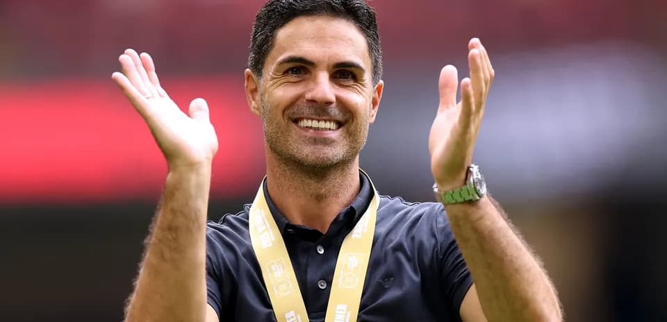 Coach celebrating with medal during victory ceremony