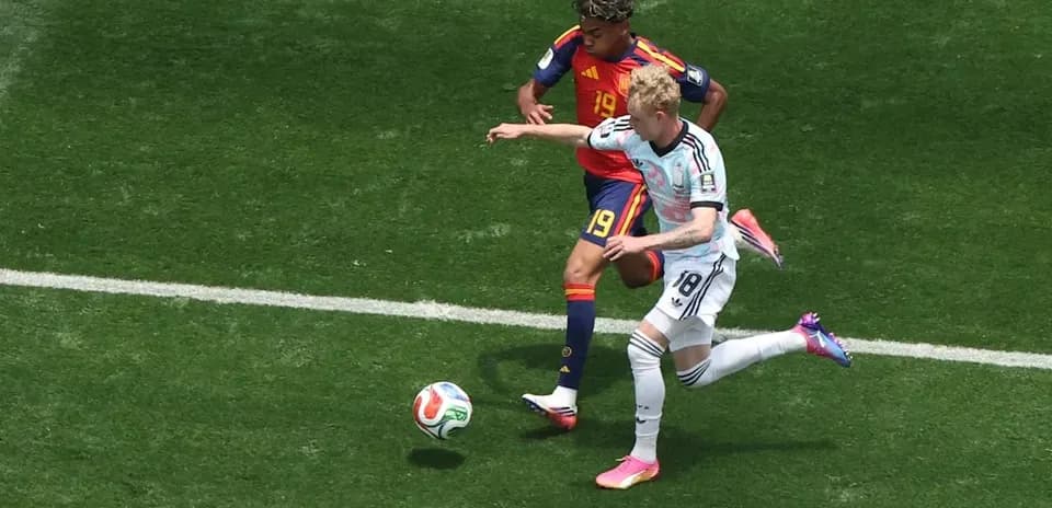 Two players contesting the ball on the field