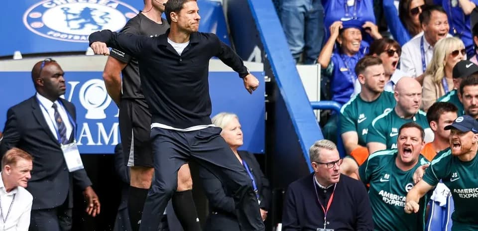 Coach celebrating during match with spectators in background