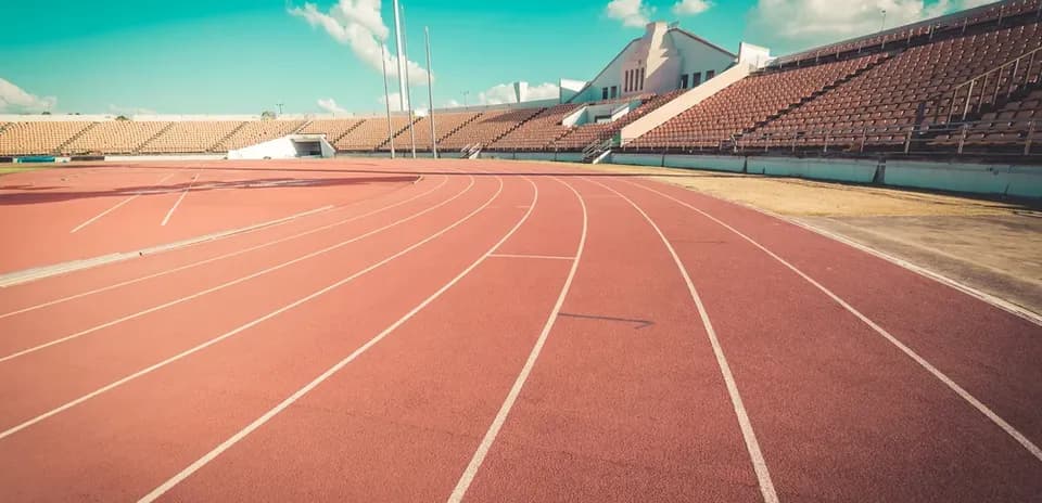 Empty athletic track and seating at stadium