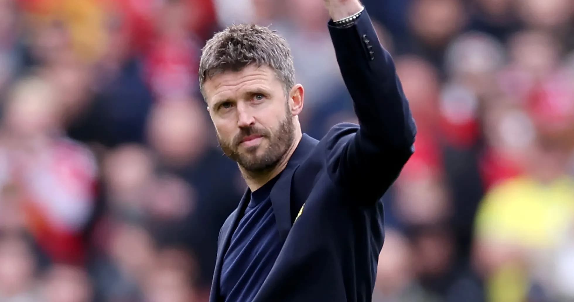Coach waving to fans during a match