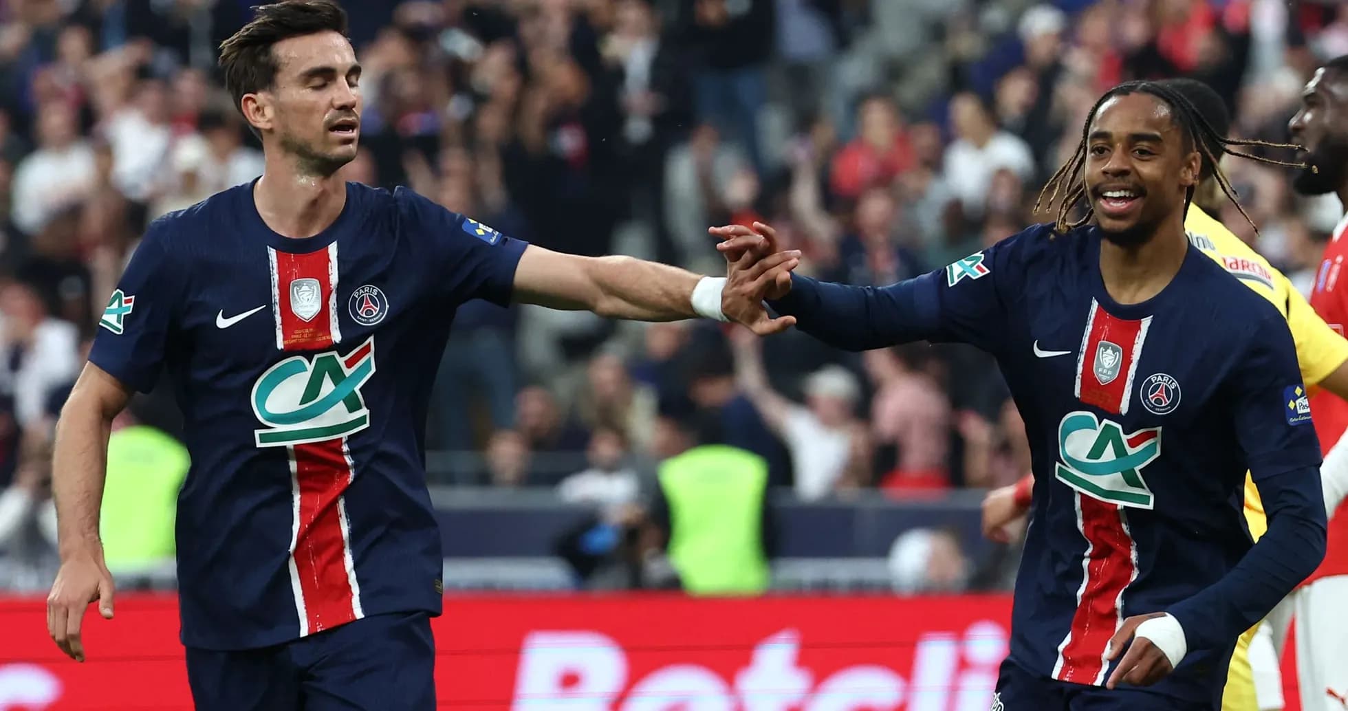 Two PSG players celebrating a goal together