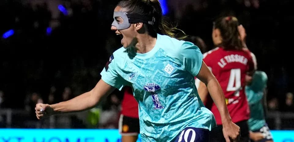Player celebrating a goal wearing a protective mask
