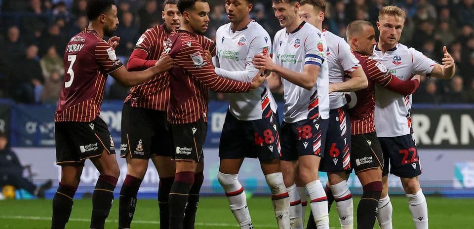 Players from both teams in a heated confrontation