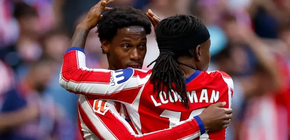 Two players celebrating a goal on the pitch