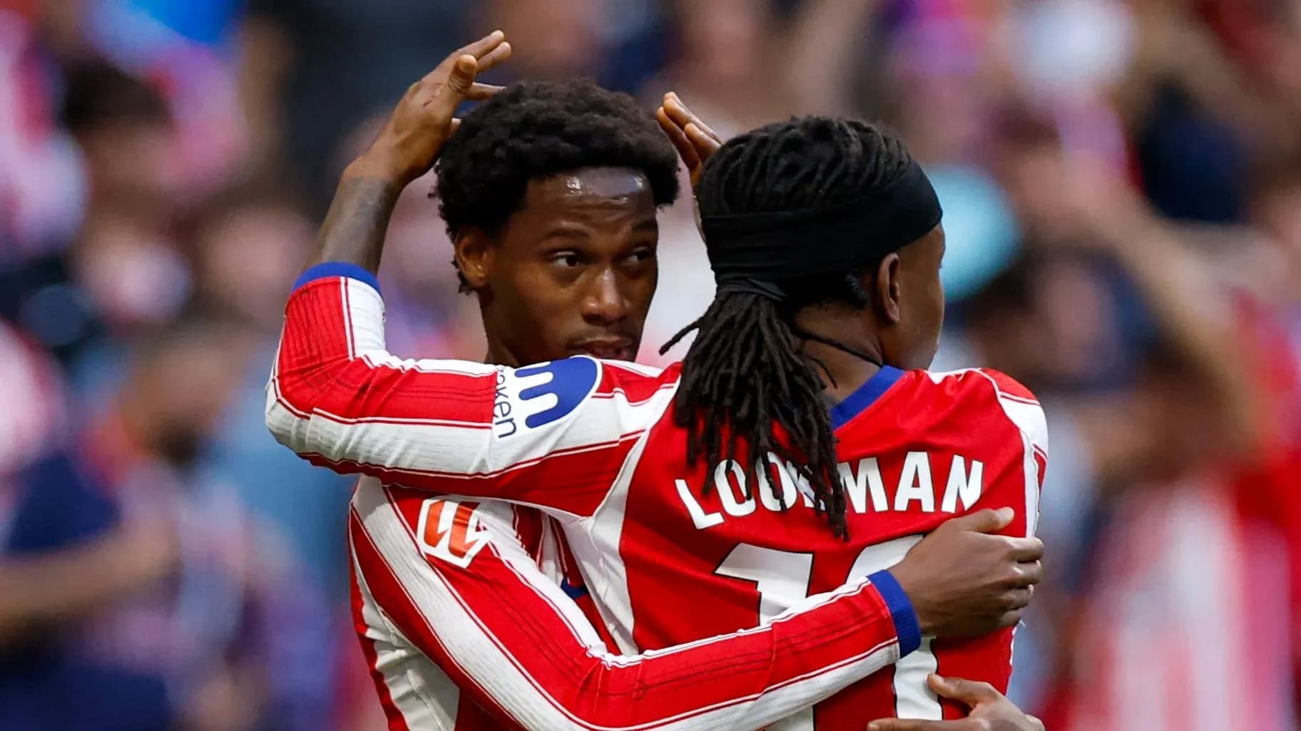 Two players celebrating a goal on the pitch
