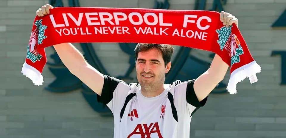 New player holding Liverpool FC scarf at announcement