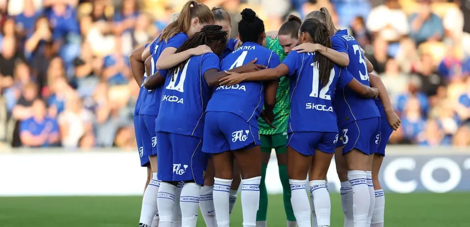 Chelsea W team huddling before the match