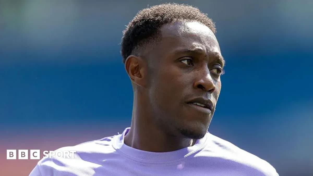 Football player in training kit looking off-camera