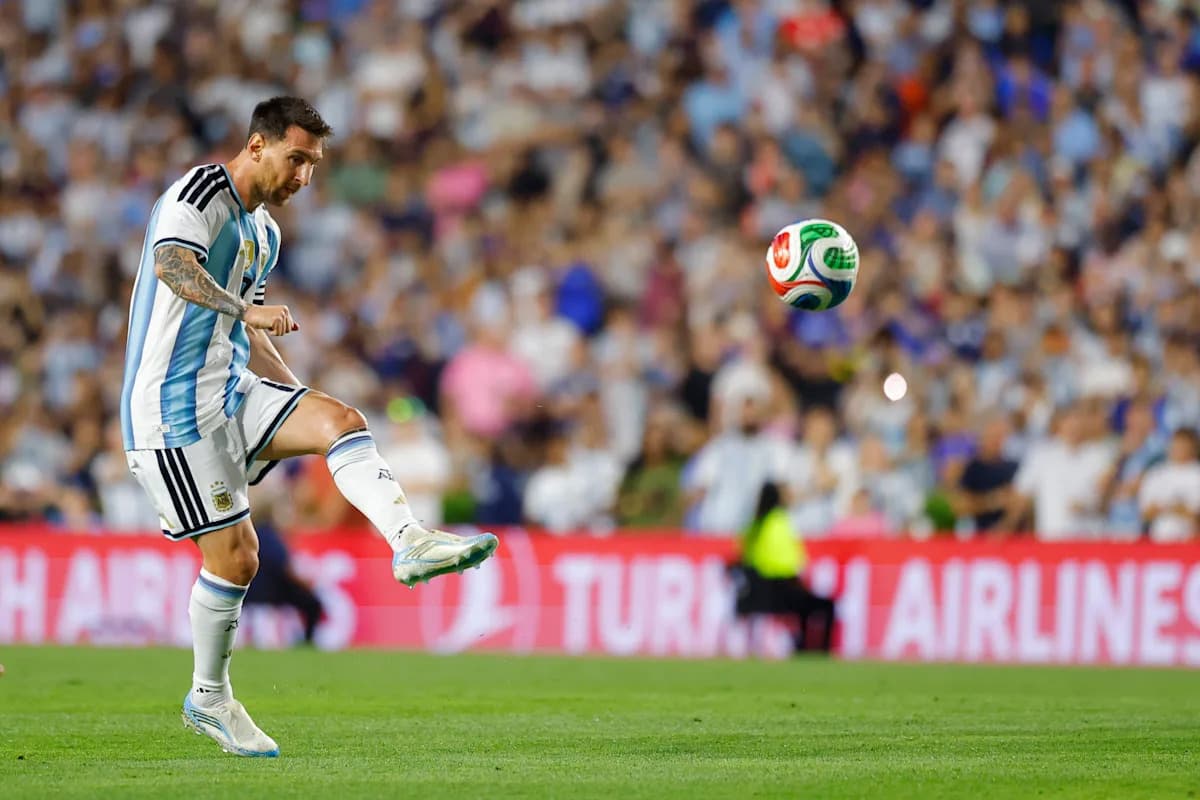 Lionel Messi preparing to kick a soccer ball