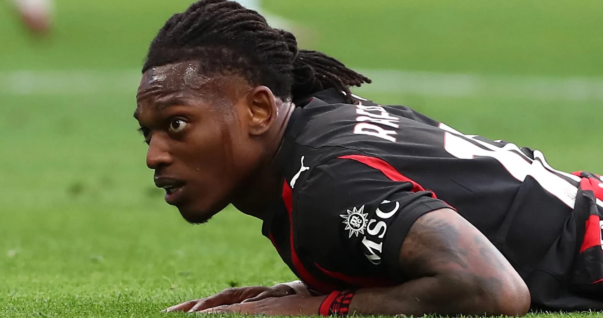 Player lying on pitch during a football match