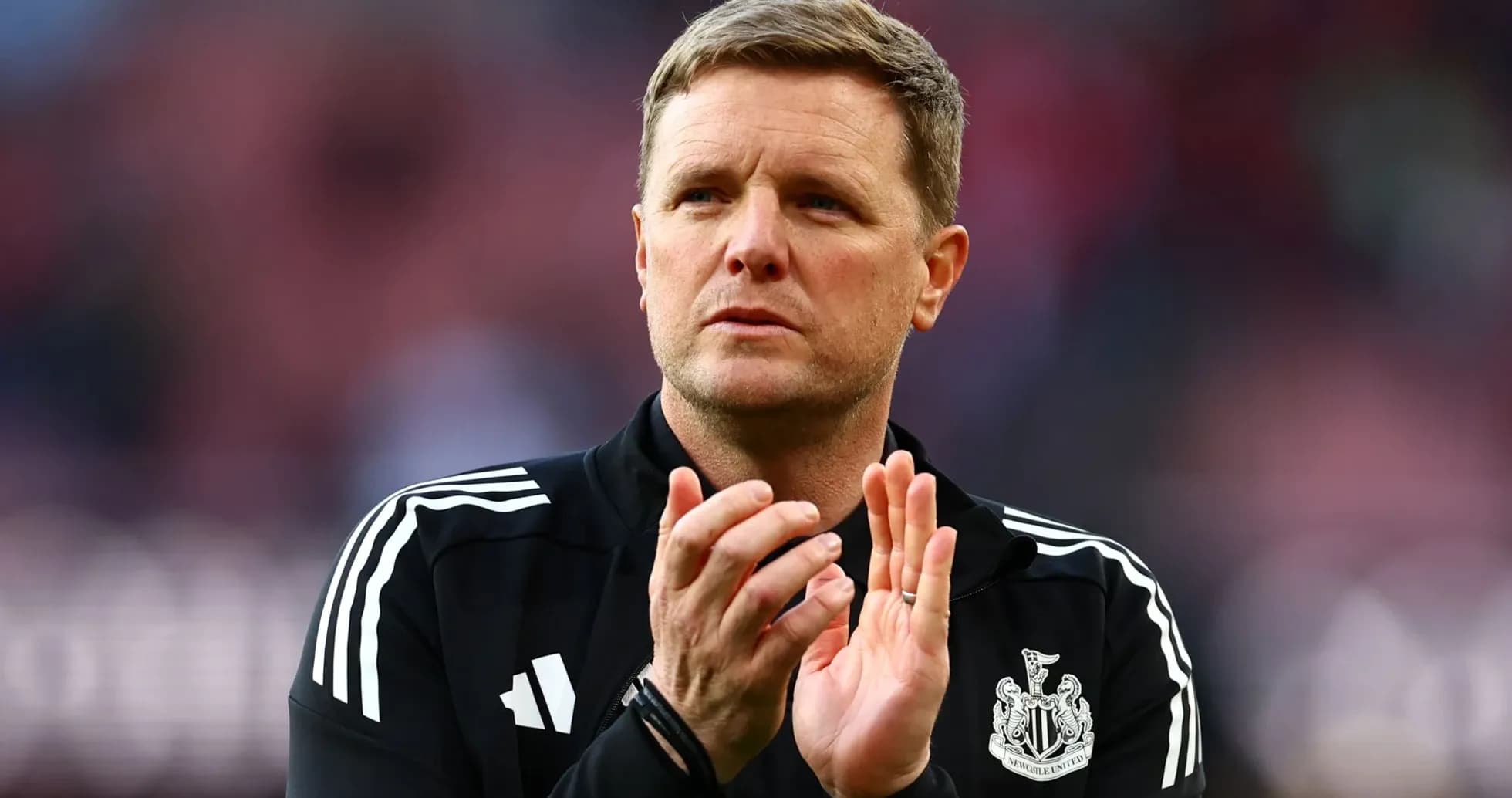 Manager applauding fans before the match