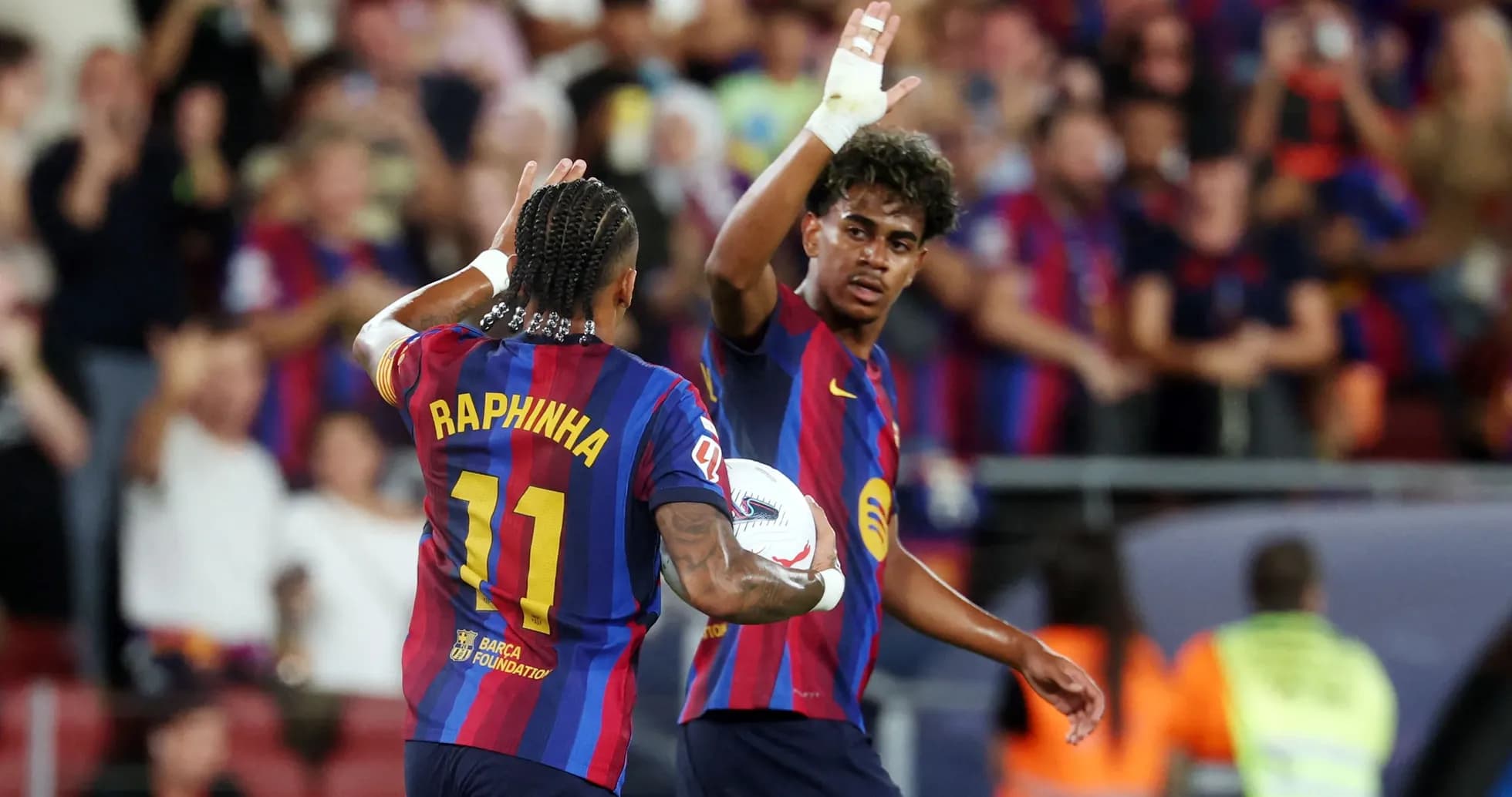 Raphinha celebrating with teammate after scoring goal