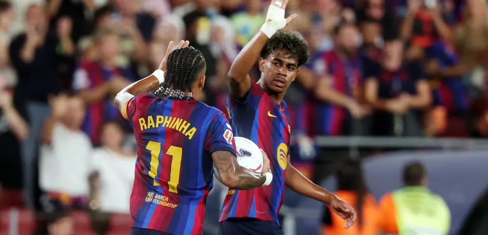 Raphinha celebrating with teammate after scoring goal