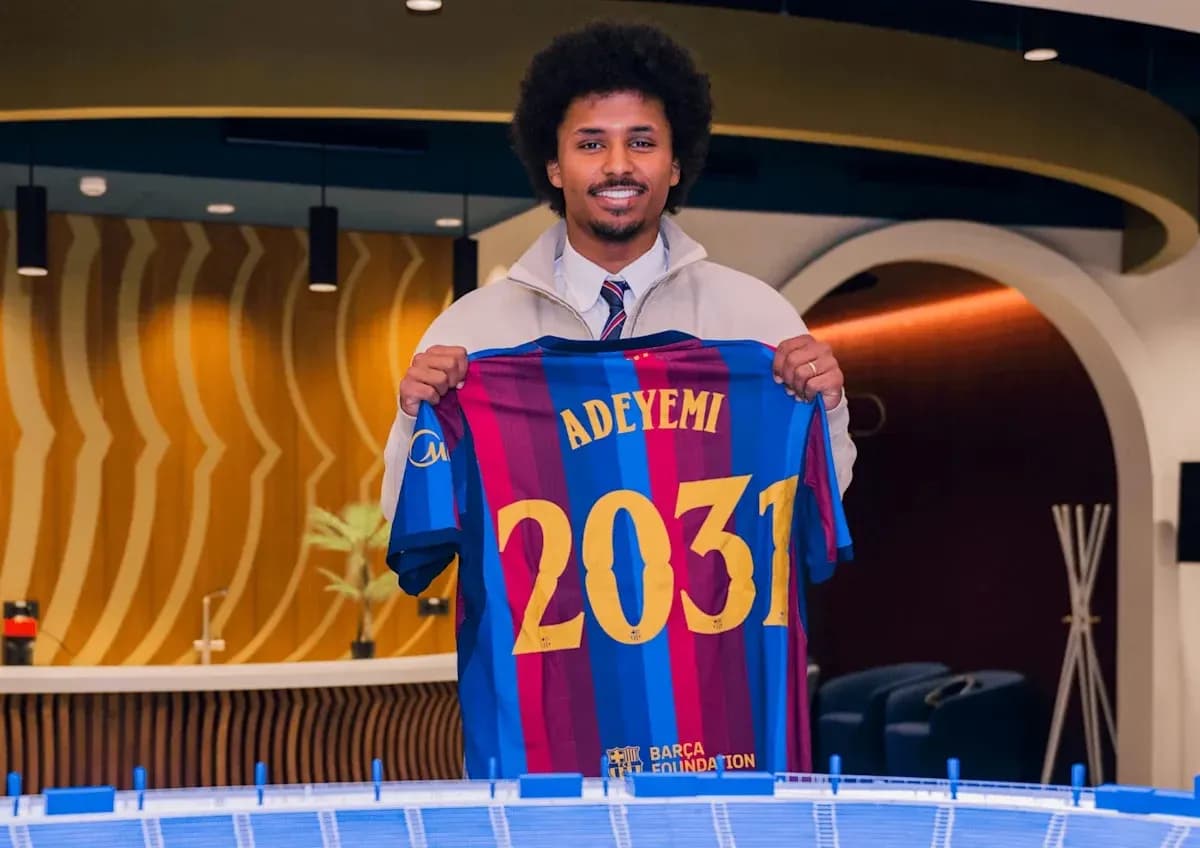 Player holding Barcelona jersey with name Adeyemi