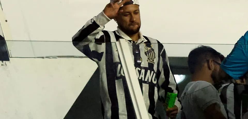 Man waving while wearing Santos FC jersey