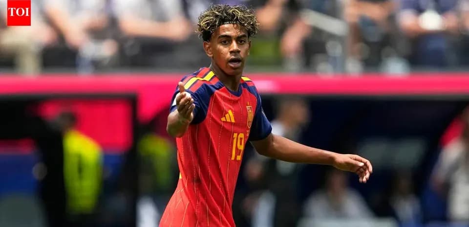 Player in Spain kit signaling during match
