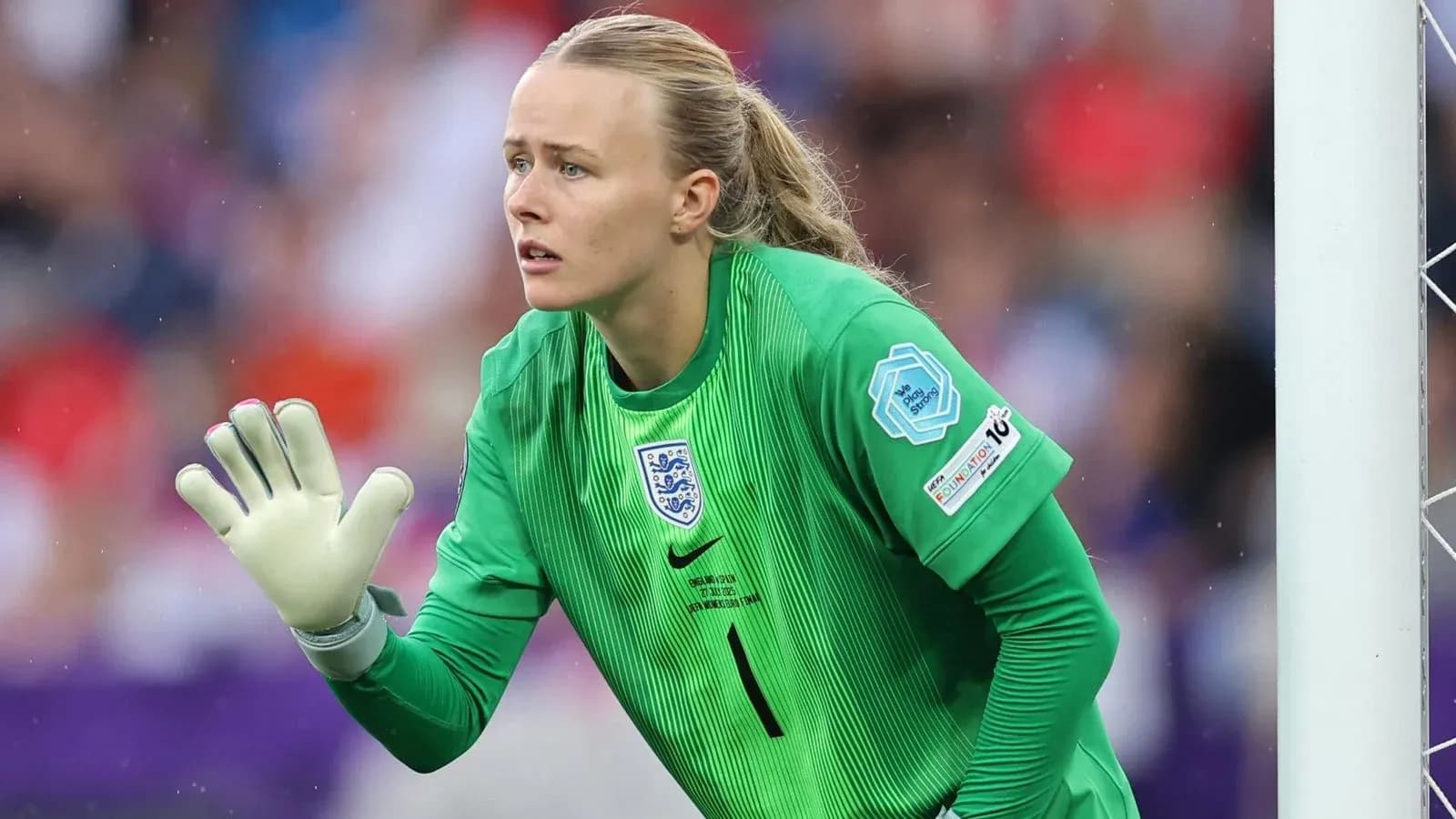 Goalkeeper in green kit preparing to make a save