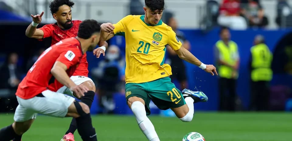 Australian player dribbling against Egyptian defenders