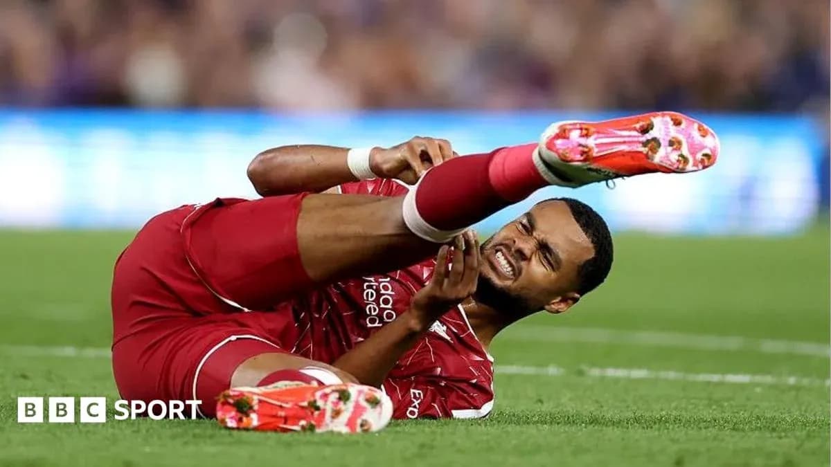 Player in red uniform down on the field injured