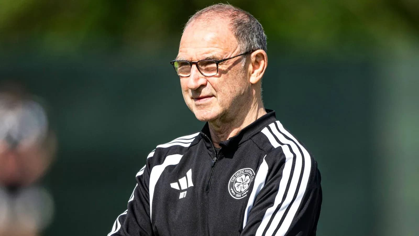 Coach observing training session at football facility