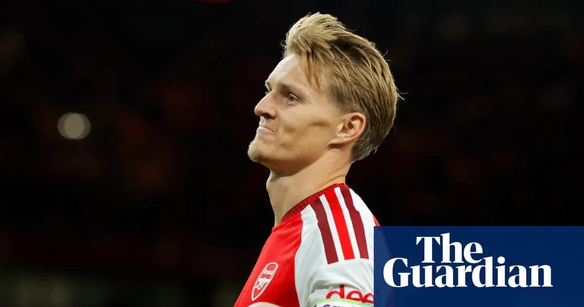Arsenal player walking off the pitch after match