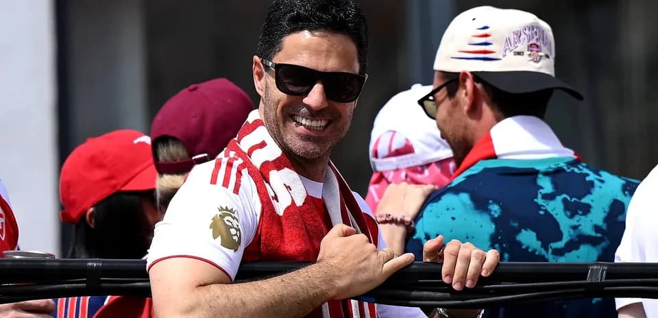 Man smiling with sunglasses and scarf at event