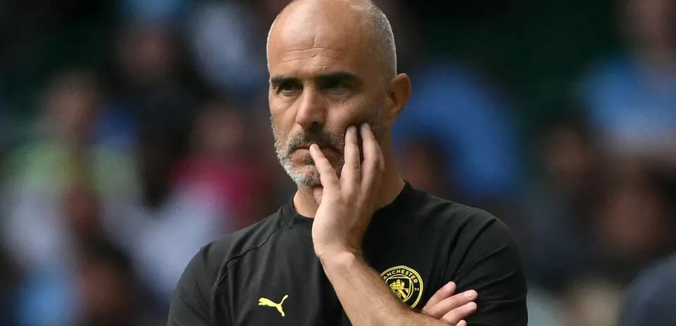 Coach observing match with hand on face