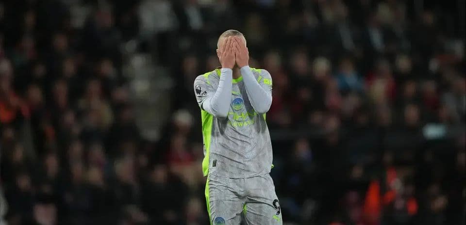 Goalkeeper with hands on face during match