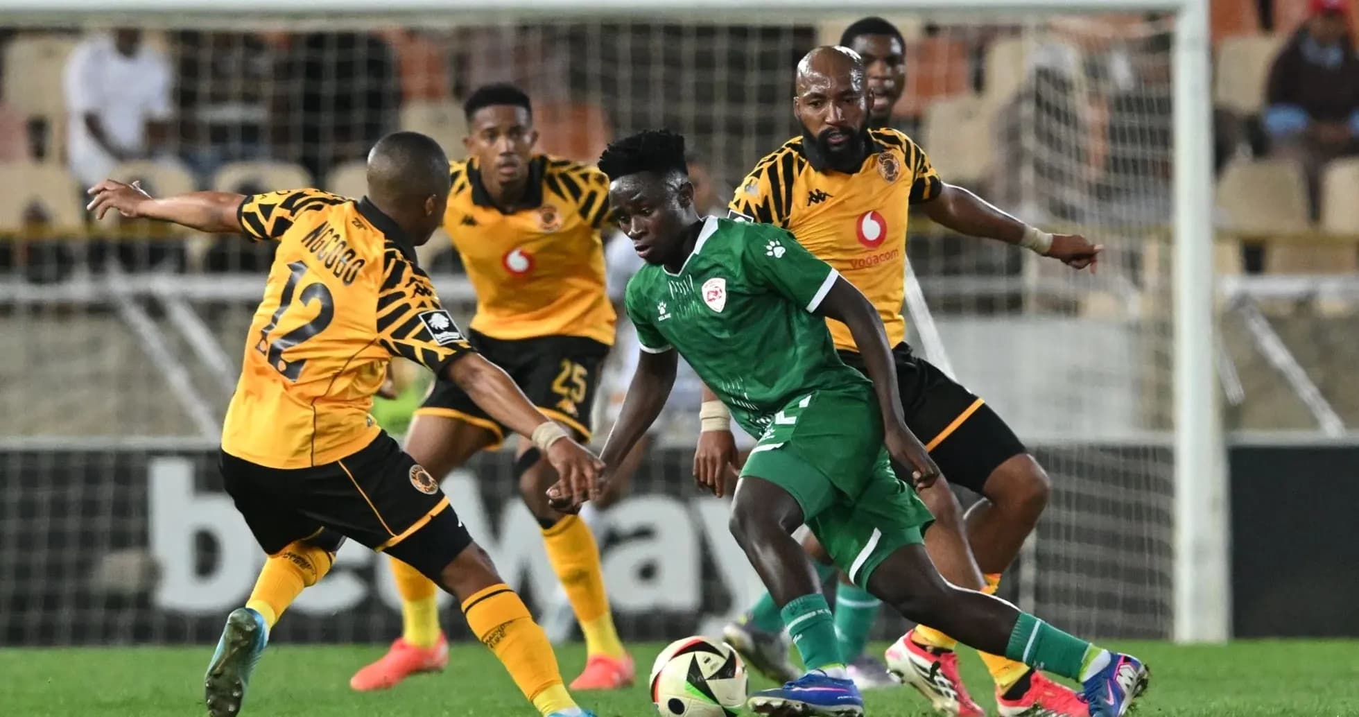 Players battling for the ball during a football match