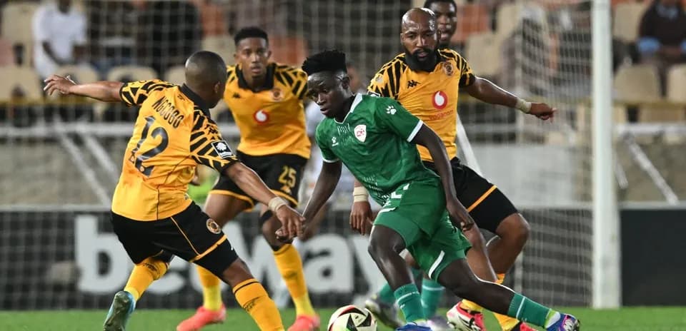Players battling for the ball during a football match