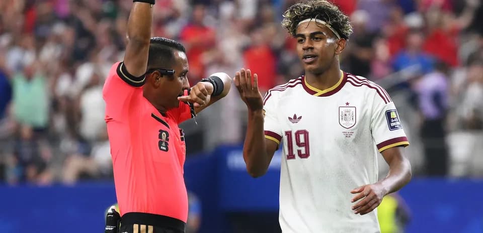 Referee giving instructions to Spanish player during match