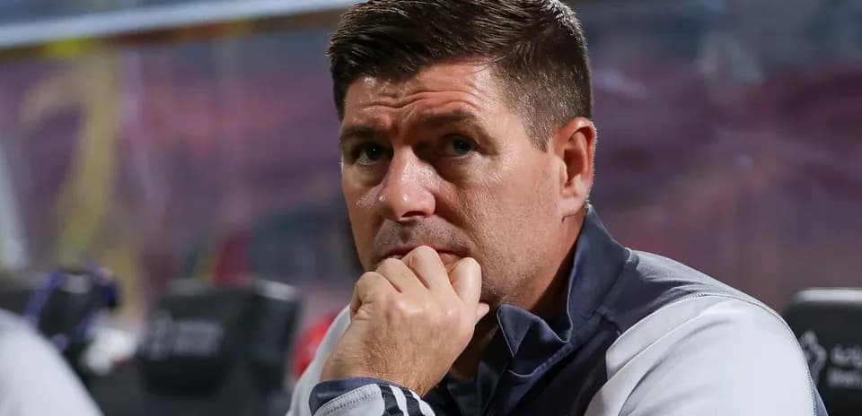 Coach sitting pensively on the sidelines