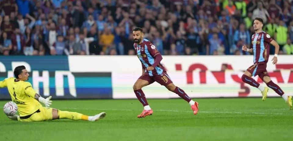 Player scoring a goal against the goalkeeper