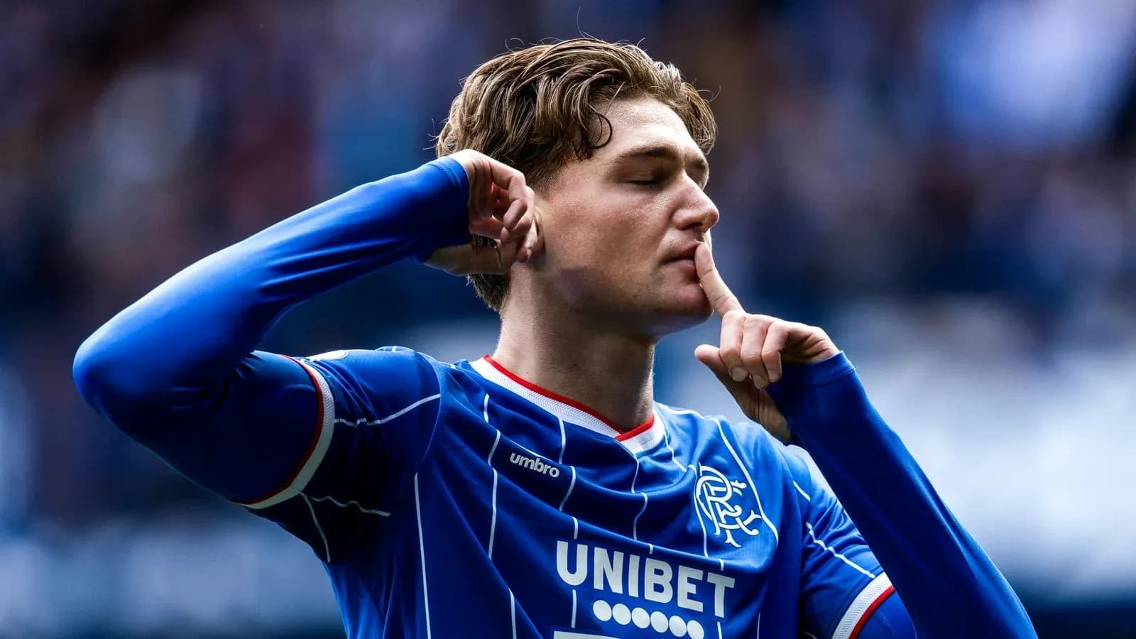 Player celebrating and signaling for silence after scoring