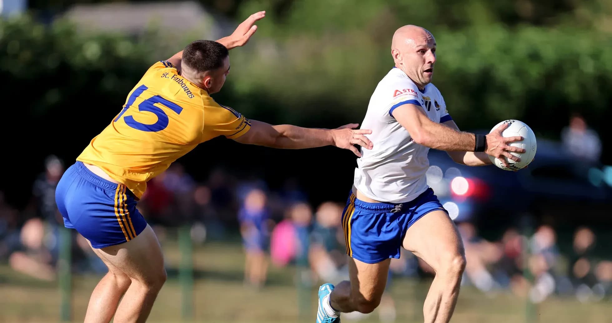 Player running with ball while being tackled
