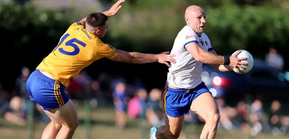 Player running with ball while being tackled