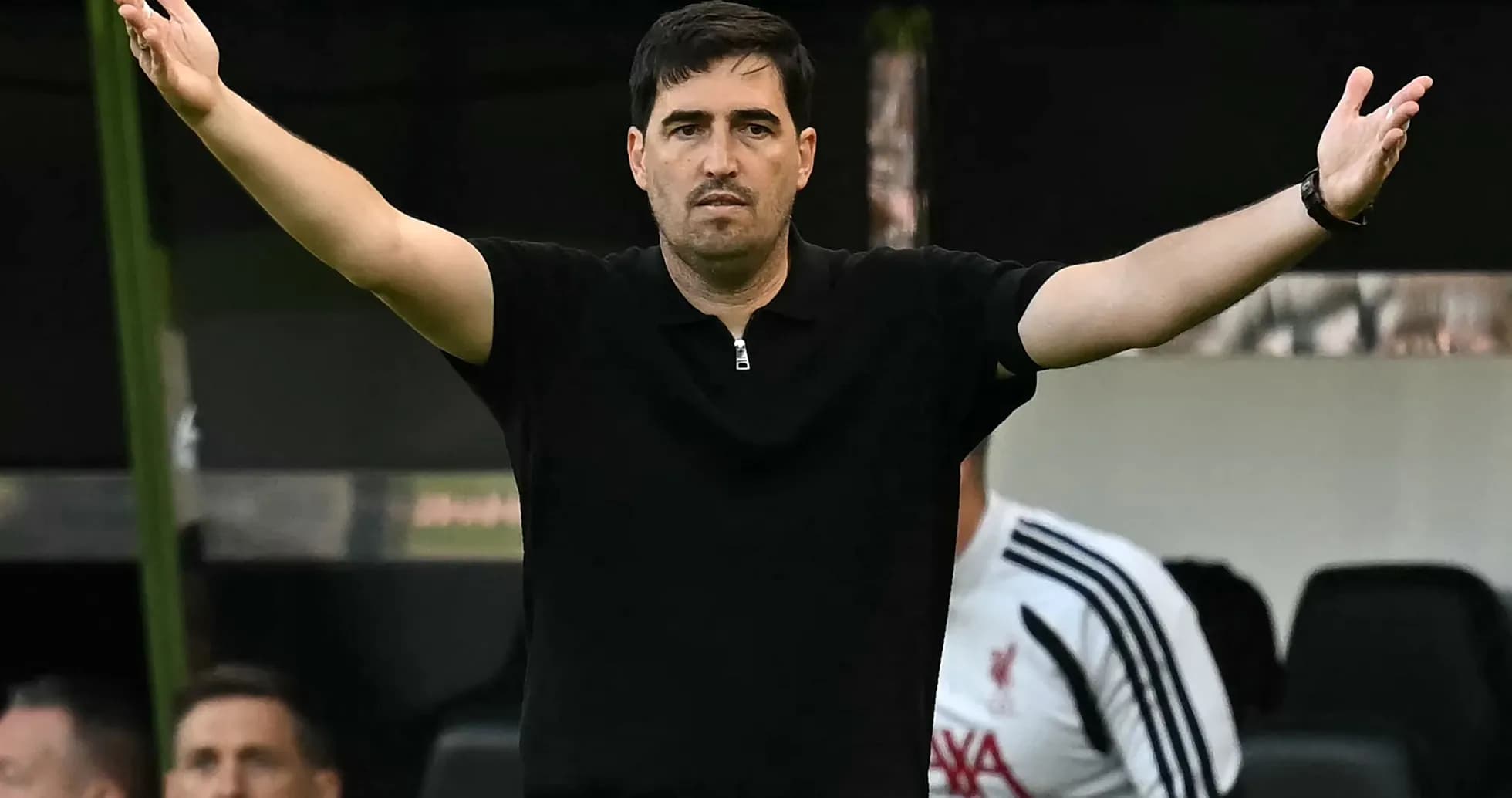 Coach gesturing during match from sidelines
