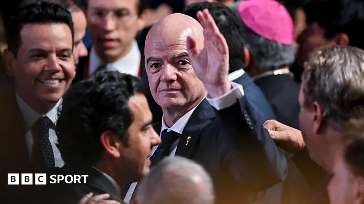 Gianni Infantino waving in crowded event setting