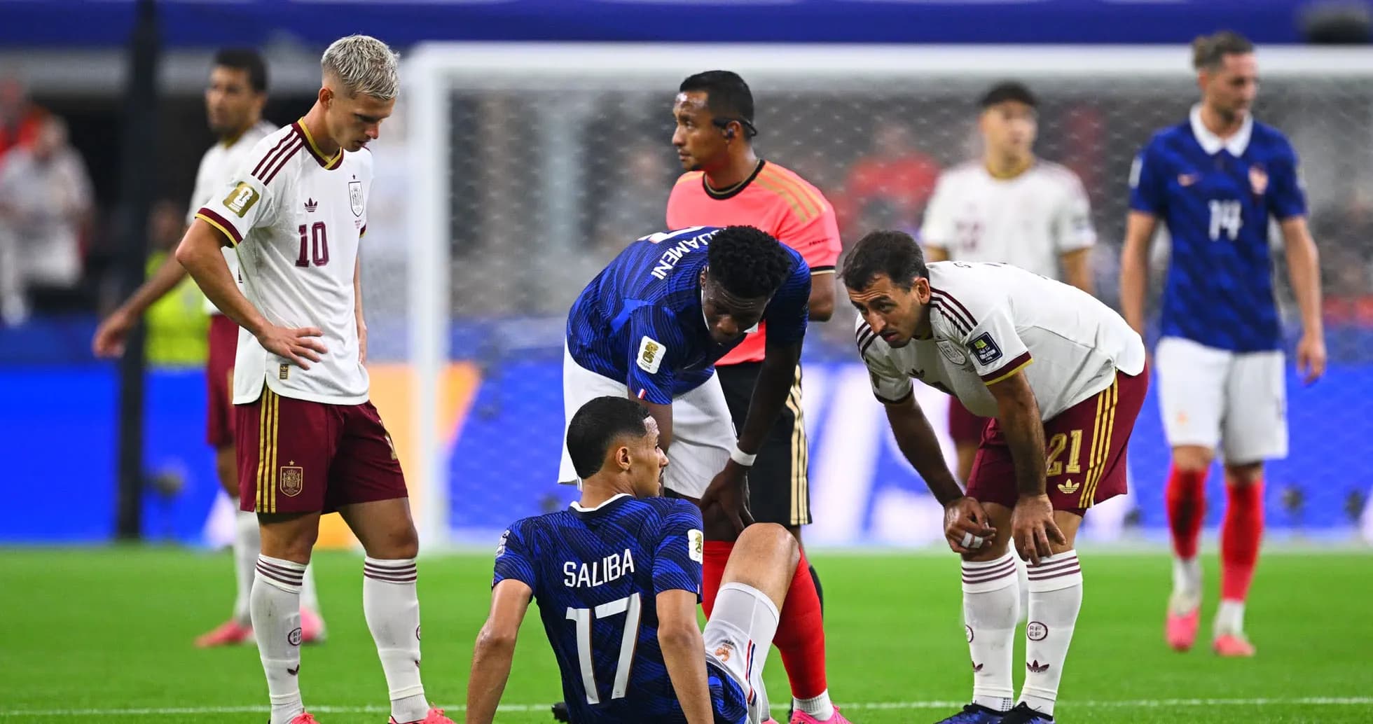 Players attending to injured player during match