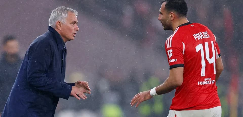 Coach speaking to player during rainy match