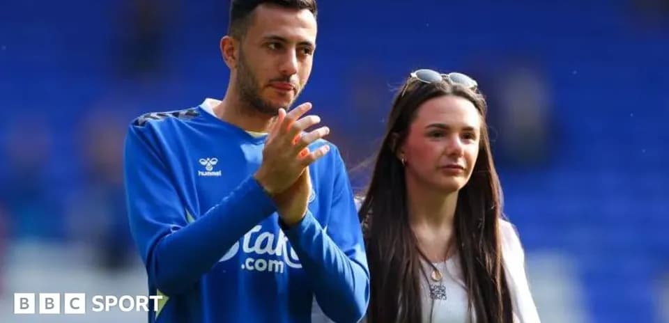 Football player and companion applauding on field