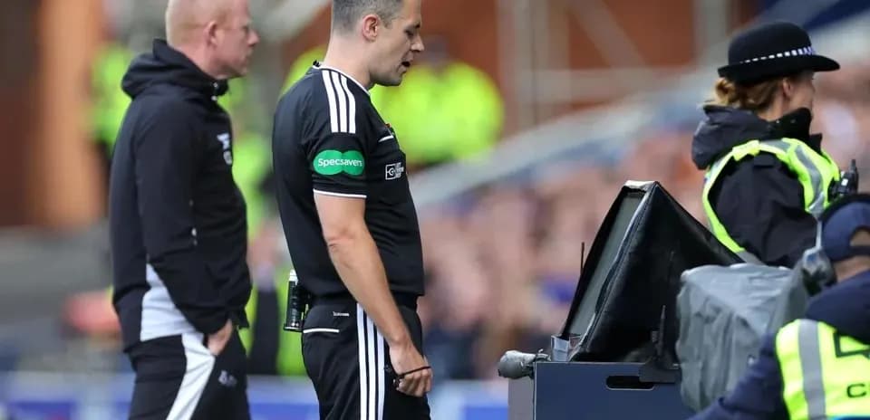 Referee reviewing a decision at VAR monitor