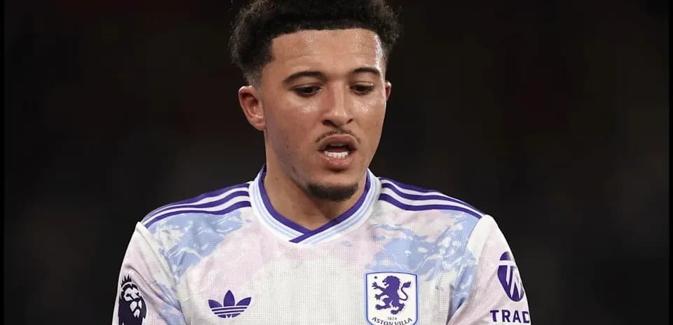 Aston Villa player during a match, looking down
