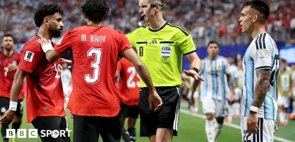 Players discussing with referee during match stoppage