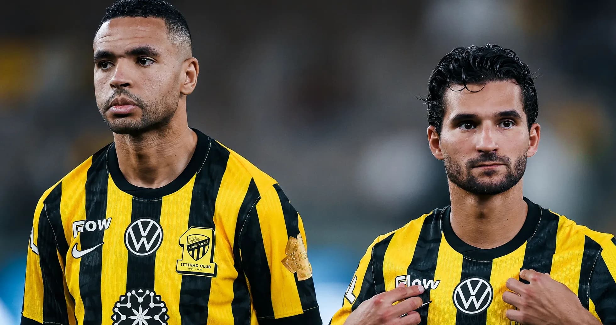 Two players in yellow and black striped jerseys