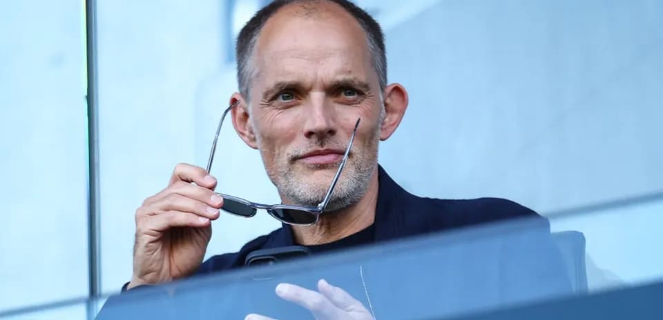 Man holding glasses in a stadium box