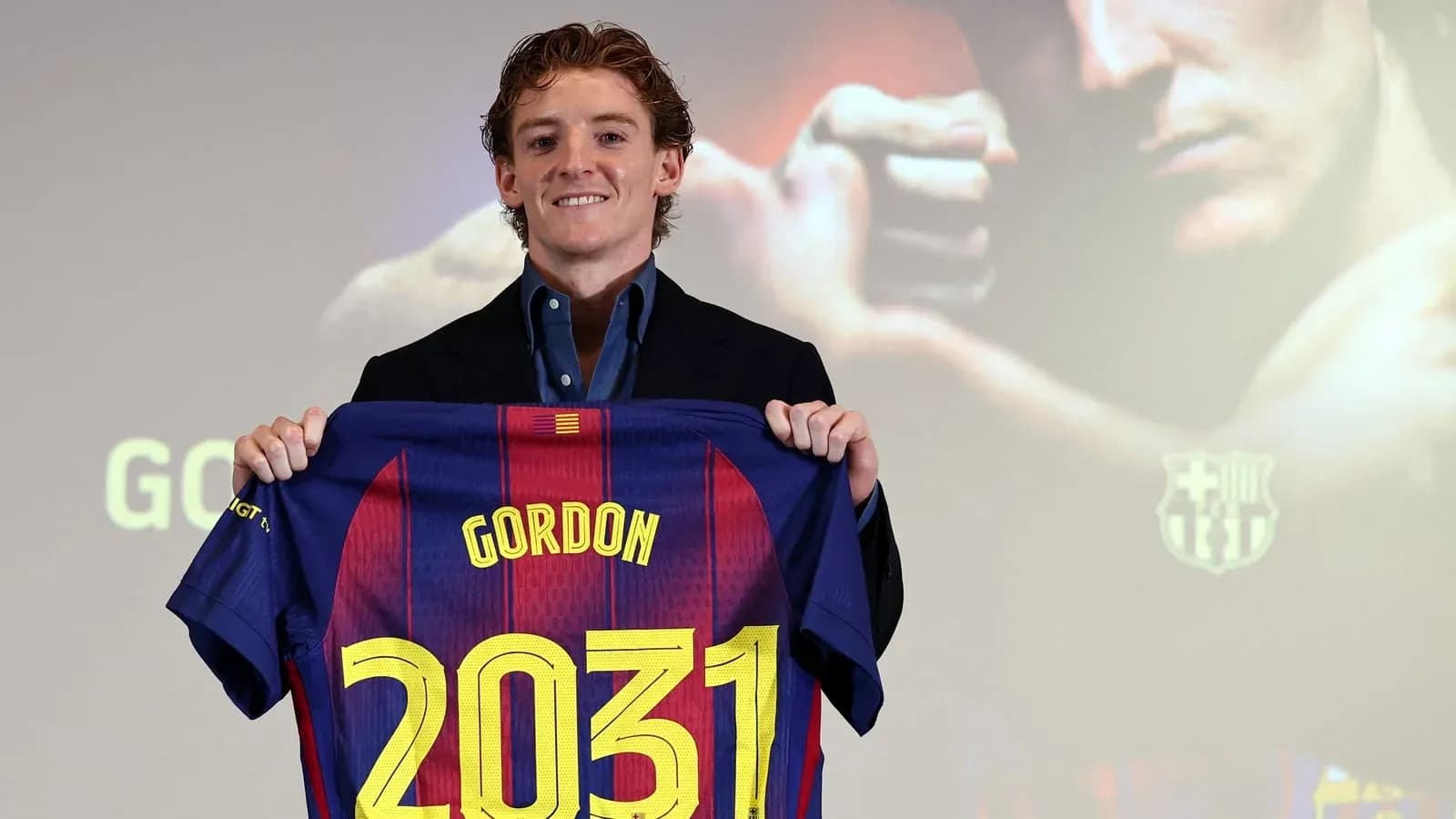 Player holding Barcelona jersey with name Gordon and number 2031