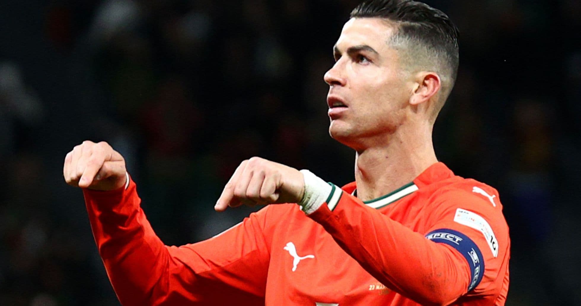 Player gesturing during match in orange jersey