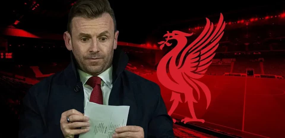 Presenter reading notes at Liverpool's stadium